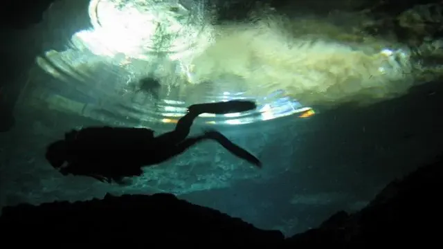 Diver silhouette in cave